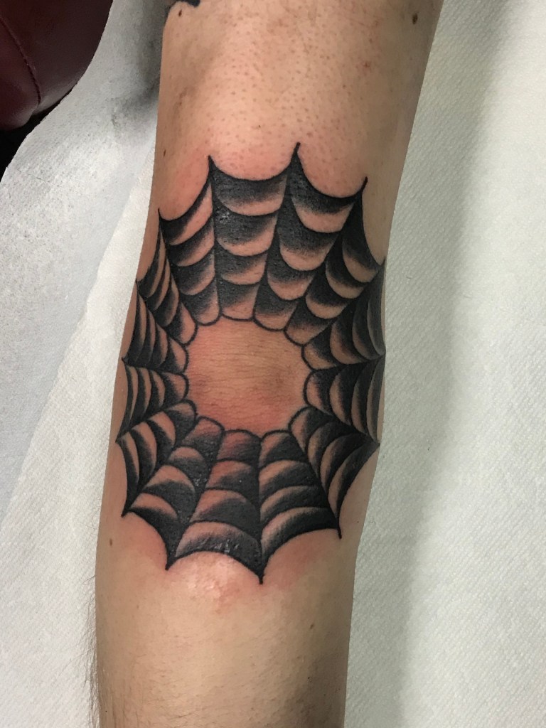 Decorative image to show artists tattoo work. Photograph of a freshly done tattoo. Tattoo is a spiderweb on an elbow